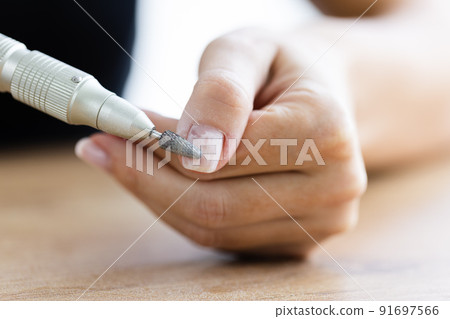 Removing shellac from the nails with fraser. Closeup. Selective focus. Removing shellac from the nails with fraser. Closeup. Selective focus. 91697566