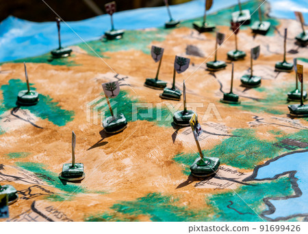 reproduction of an ancient medieval map with flags to mark the war disposition reproduction of an ancient medieval map with flags to mark the war disposition 91699426