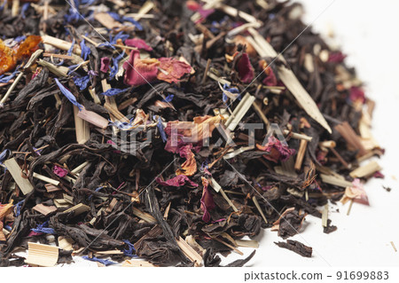 black tea with lemongrass, currant berries, sea buckthorn berries, rose petals, cornflower petals isolated on white background 91699883