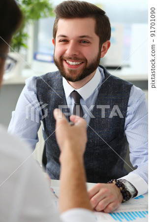 Smiling businessman communicates with business project partner Smiling businessman communicates with business project partner 91701090