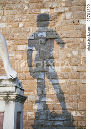Shadow of statue of David by Michelangelo on Palazzo Vecchio of Florence. Piazza della Signoria, Tuscany region of Italy Shadow of statue of David by Michelangelo on Palazzo Vecchio of Florence. Piazza della Signoria, Tuscany region of Italy 91701200