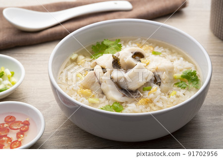 Fish Porridge,rice soup with sliced Tilapia fish.Asian breakfast style Fish Porridge,rice soup with sliced Tilapia fish.Asian breakfast style 91702956