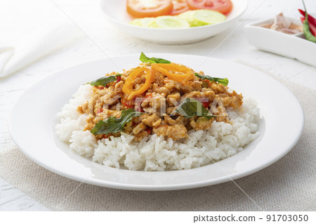 Rice topped with stir-fried minced chicken and basil (Gai Pad Grapow).asian food Rice topped with stir-fried minced chicken and basil (Gai Pad Grapow).asian food 91703050