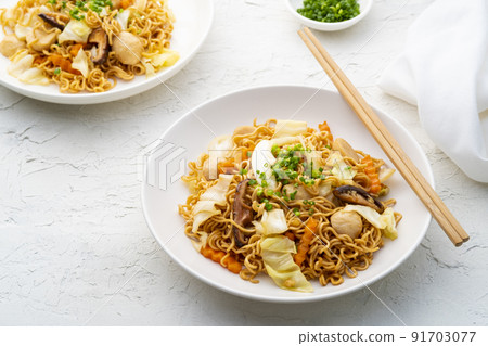 stir fried instant noodle with meatballs and vegetables with yakisoba sauce in white plate 91703077