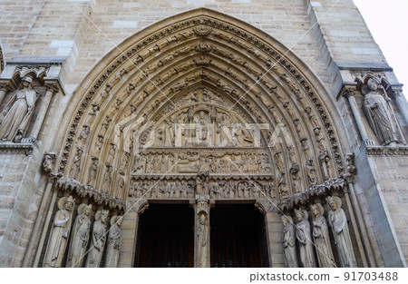 Marvelous sculptural and architectural details of Notre Dame Cathedral in Paris France. Before the fire. April 05, 2019 91703488
