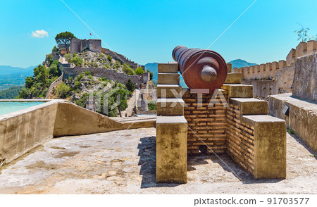 Iron cannon in the picturesque hilltop Xativa Castle. Spain Iron cannon in the picturesque hilltop Xativa Castle. Spain 91703577