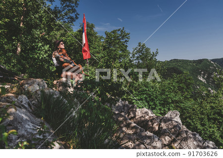 Woman and Dog Relaxing after Hiking in Mountains Woman and Dog Relaxing after Hiking in Mountains 91703626