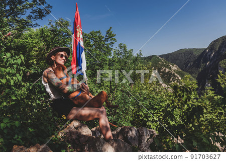 Woman and Dog on Mountain Peak in Serbia 91703627