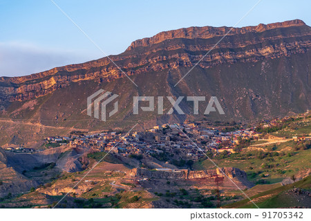 evening view of the mountain village of Chokh in Dagestan on the slope of a vast valley evening view of the mountain village of Chokh in Dagestan on the slope of a vast valley 91705342