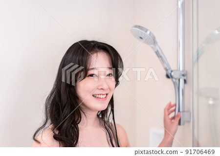 Young woman taking a shower 91706469