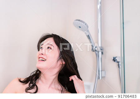 Young woman taking a shower Young woman taking a shower 91706483
