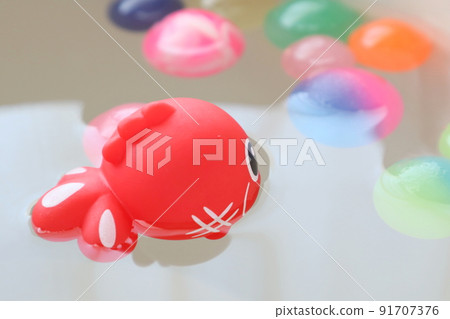 Cute goldfish and colorful bouncy balls 91707376