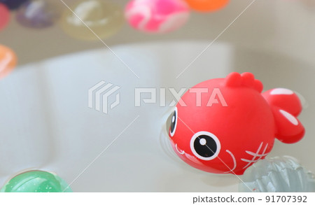 Cute goldfish and colorful bouncy balls 91707392