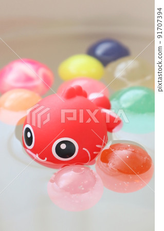 Cute goldfish and colorful bouncy balls 91707394