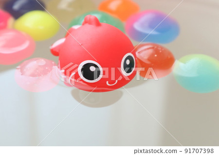 Cute goldfish and colorful bouncy balls 91707398