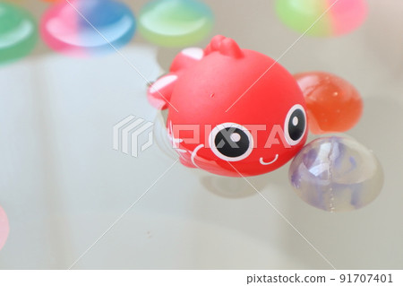 Cute goldfish and colorful bouncy balls 91707401