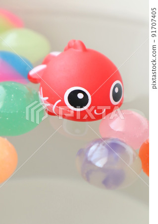 Cute goldfish and colorful bouncy balls 91707405