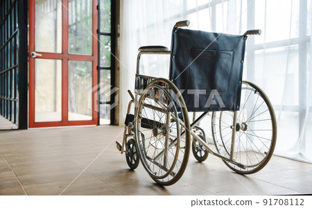Close up view of empty wheelchair waiting for patient services with vintage filtered. Close up view of empty wheelchair waiting for patient services with vintage filtered. 91708112