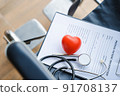 close up heart ball and stethoscope on empty wheelchair. 91708137