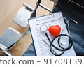 close up heart ball and stethoscope on empty wheelchair. 91708139