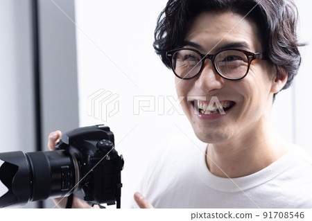 Photographer with a camera in the shooting studio 91708546