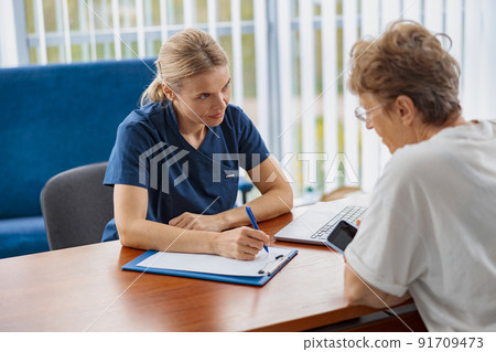 Therapist conducts a preventive examination of a woman in her office in a modern clinic 91709473