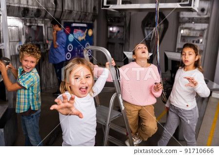 Emotional preteen girl trying to reach for something in quest room bunker 91710666