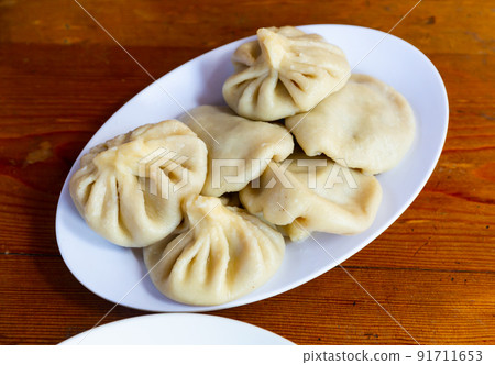 Georgian traditional boiled Khinkali dumplings with spiced meat 91711653