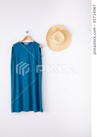 A light blue dress hung on a white wall Blue dress 91714067