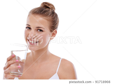 Its her beauty secret. A cute young girl with perfect skin drinking water while isolated on white. Its her beauty secret. A cute young girl with perfect skin drinking water while isolated on white. 91718908