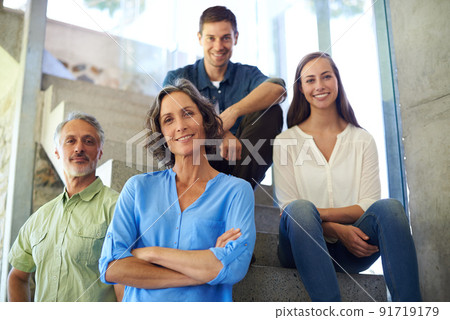 Welcome to our happy home. Shot of a mother and father standing in front of their adult children on the stairs. 91719179