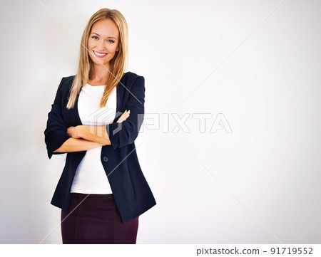 Shes dressed for success. Shot of well dressed woman looking at the camera. 91719552
