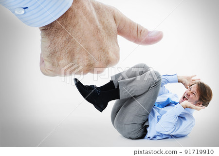 Fear of success. Studio shot of a scared businessman protecting himself from a giant thumbs up. 91719910