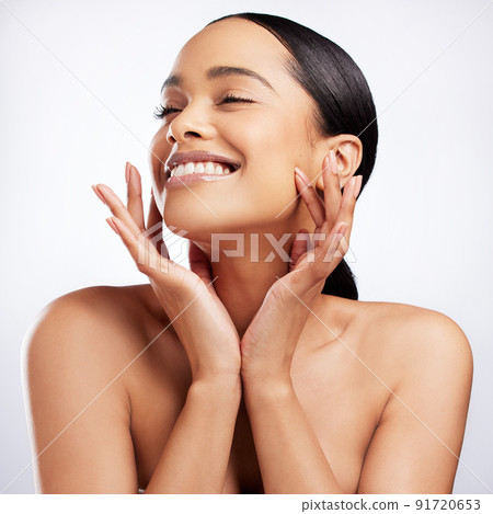 Oh how I love the feeling of glowing skin. Studio shot of a beautiful young woman posing against a white background. 91720653
