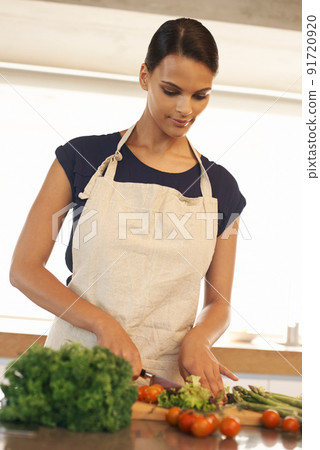Fresh is best. Cropped shot of a beautiful woman standing in her kitchen a home. 91720920