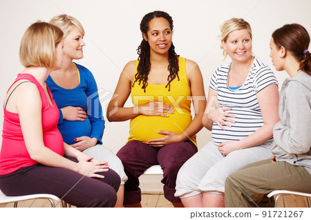 Discussing their hopes and dreams. A group of pregnant women sitting down together to share their feelings. Discussing their hopes and dreams. A group of pregnant women sitting down together to share their feelings. 91721267
