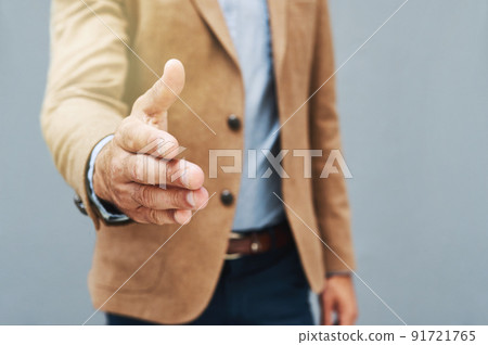 Its all about making the right connections. Cropped shot of a businessman extending his arm to shake hands against a gray background. Its all about making the right connections. Cropped shot of a businessman extending his arm to shake hands against a gray background. 91721765
