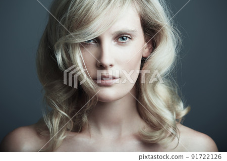 Elegant and flawless. Studio shot of a beautiful young woman posing against a gray background. Elegant and flawless. Studio shot of a beautiful young woman posing against a gray background. 91722126