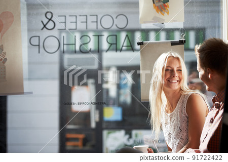 Coffee date. A young couple having a fun date in a coffee shop. 91722422