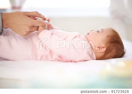 Mommy just close your nose before we do this. Loving mother caring for her baby girl. 91723028