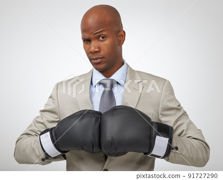 Ready to take on all business competition. Studio shot of an african american businessman wearing boxing gloves. 91727290