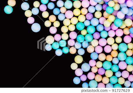 Foam beads of various colors brightly colored on black color background 91727629