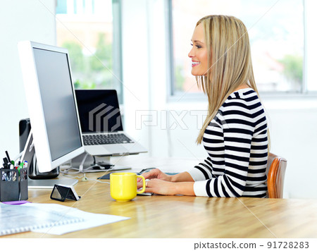 Whatever you choose to do today, make it good. Shot of a beautiful young woman working at her office desk. 91728283
