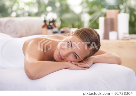 This is perfect relaxation. A young woman on a massage table in a spa. 91728304