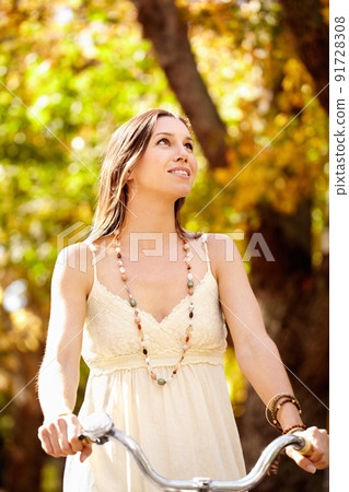 Autumn beauty. Shot of an attractive young woman in the park on an autumn day. Autumn beauty. Shot of an attractive young woman in the park on an autumn day. 91728308