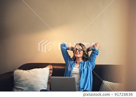Im sure my followers will enjoy this blog post. Shot of a relaxed young woman using a laptop on the sofa at home. Im sure my followers will enjoy this blog post. Shot of a relaxed young woman using a laptop on the sofa at home. 91728636