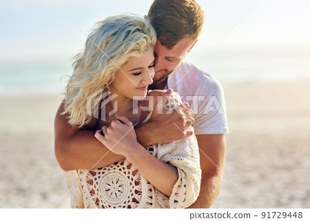 You deserve to escape every once a while. Cropped shot of n affectionate couple spending the day at the beach. 91729448
