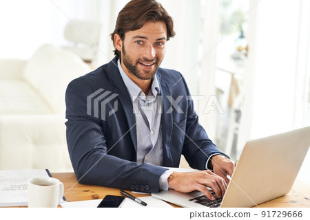 Having a productive day. An attractive businessman working on his laptop. Having a productive day. An attractive businessman working on his laptop. 91729666