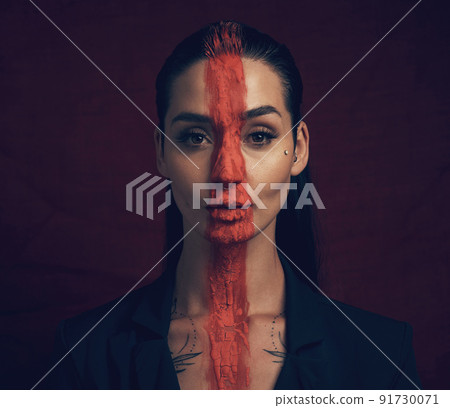 It takes courage to grow up and become who you really are. Studio shot of a young woman posing with paint on her face on a black background. It takes courage to grow up and become who you really are. Studio shot of a young woman posing with paint on her face on a black background. 91730071
