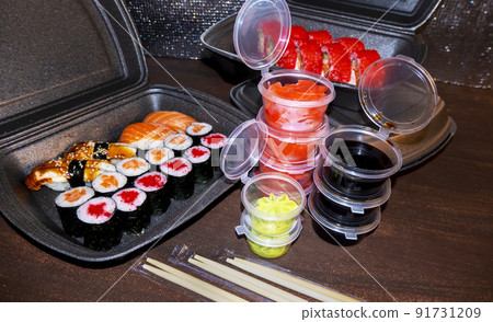 Set of delicious sushi rolls with wassabi and ginger in a box. Japanese food. Set of delicious sushi rolls with wassabi and ginger in a box. Japanese food. 91731209